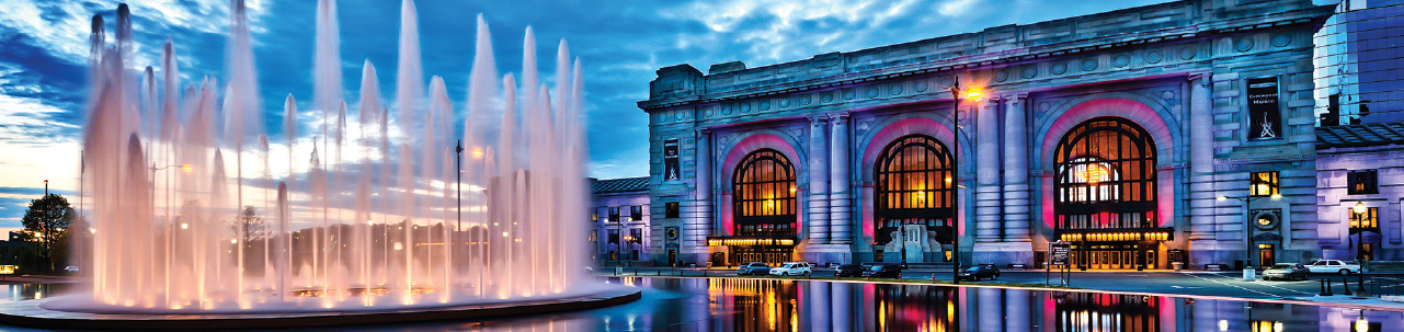 Fountain in Front of Union Station with purple lights projected on the facade