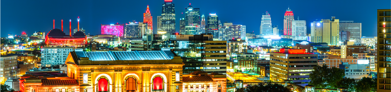 Kansas City skyline at night, with buildings illuminated 