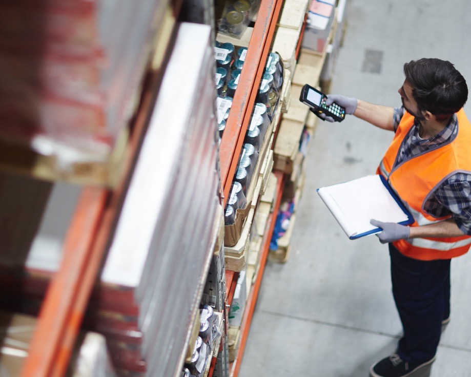 Product picker scanning barcodes at a distribution facility