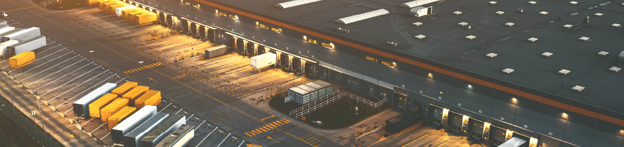 Aerial view of large distribution center with dozens of bays for trailers